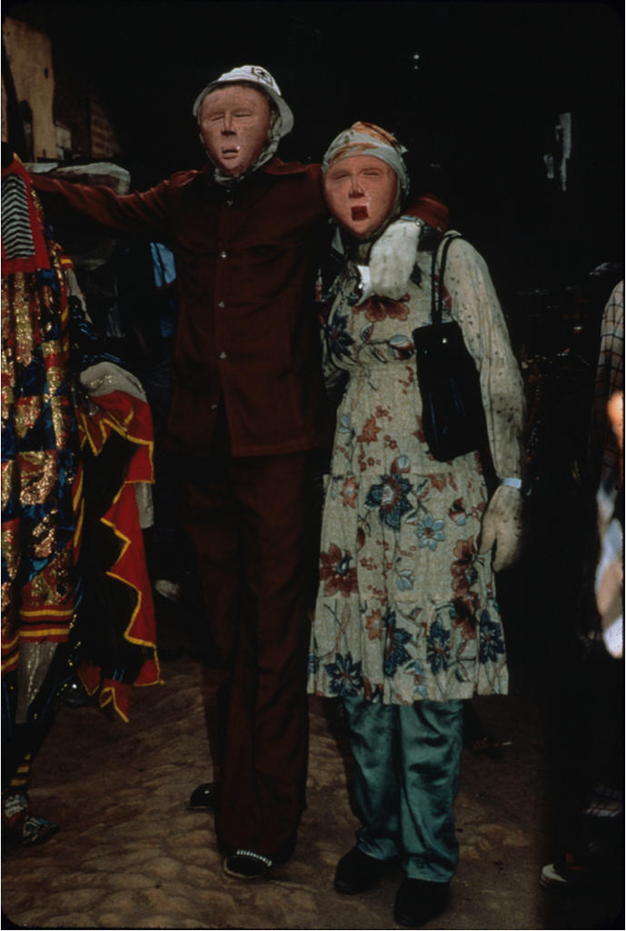 A European couple comes out and acts in a variety of ways that, according to Yorùbá etiquette, are funny and inappropriate (such as kissing in public and writing notes to each other instead of talking), 1982. Photo: Margaret T. Drewal.